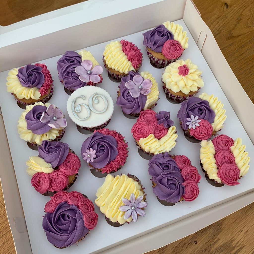 6oth birthday cupcakes in pink, purple and white.